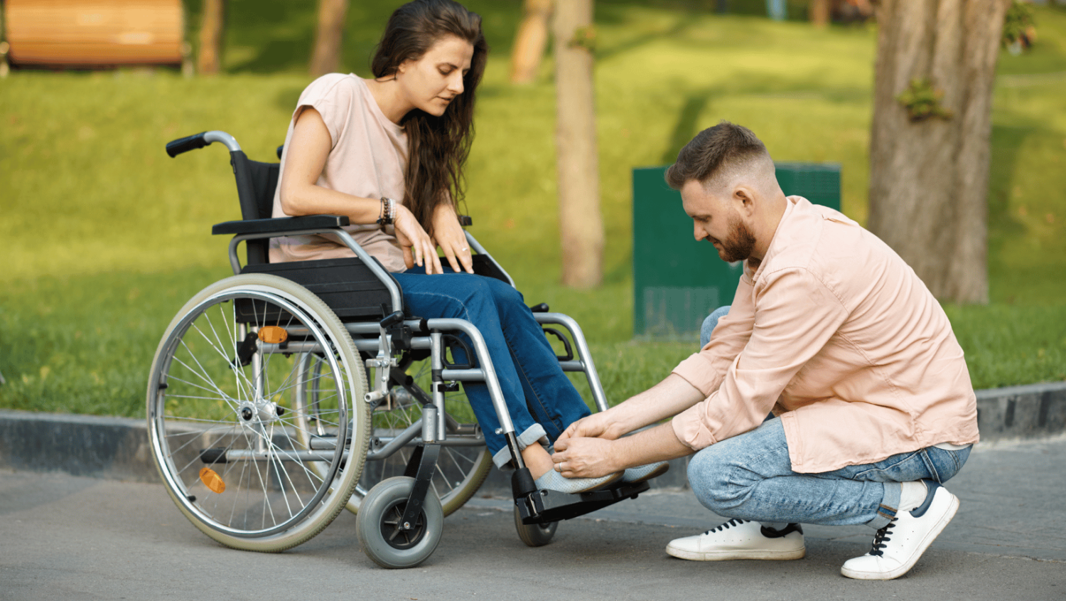 man-ties-shoe-of-lady-in-wheelchair