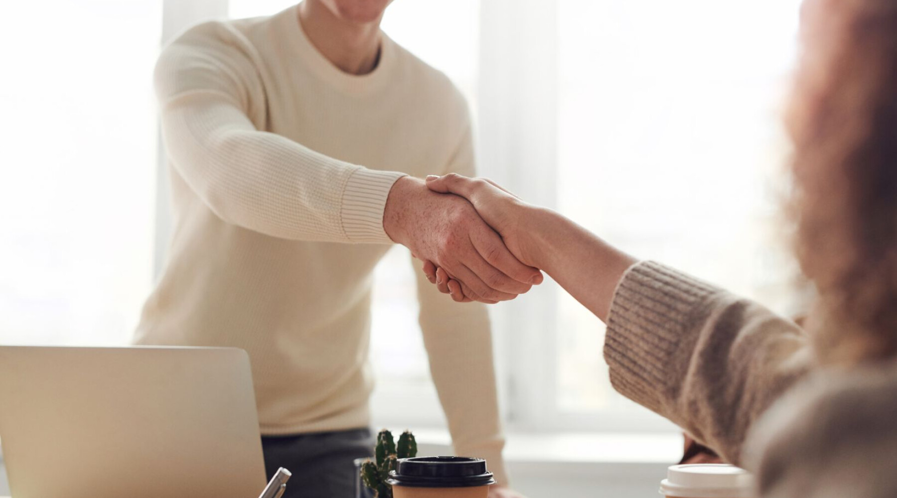 man-shakes-hand-with-woman