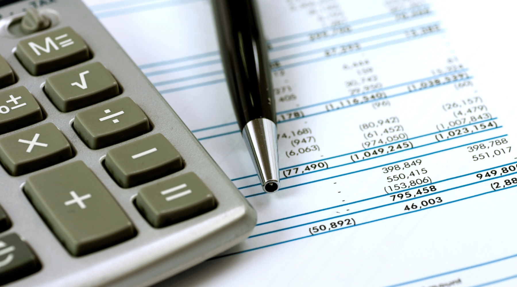 calculator and pen on financial document