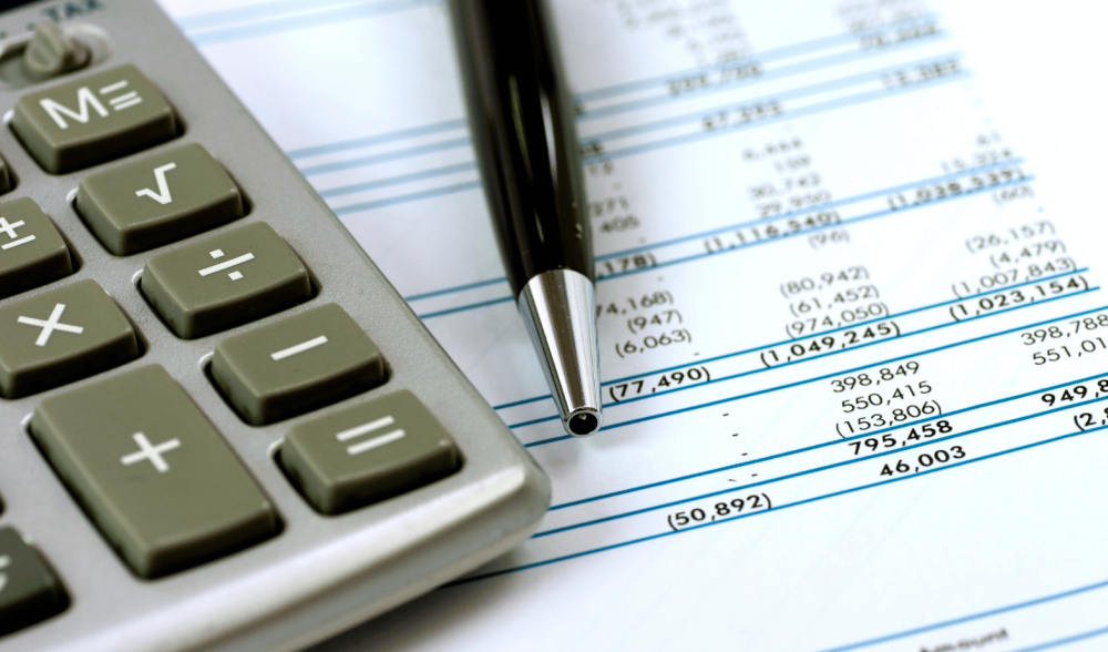 calculator and pen on financial document