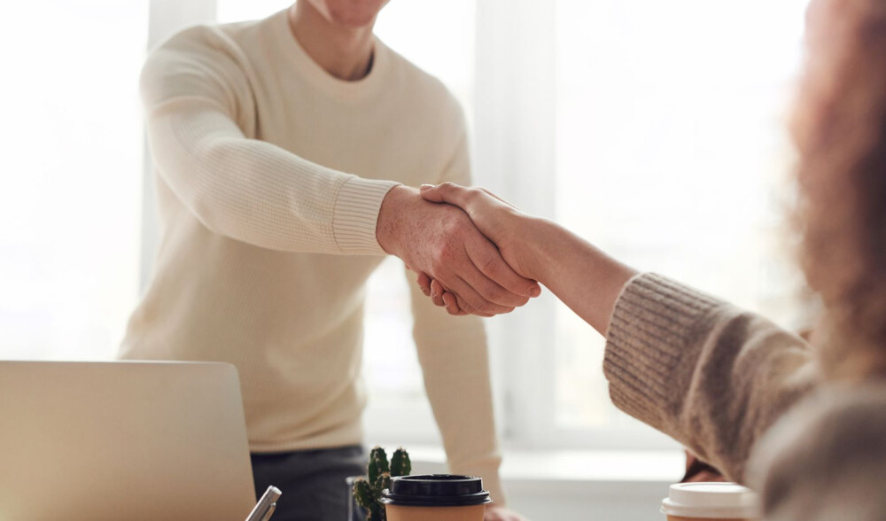 man-shakes-hand-with-woman