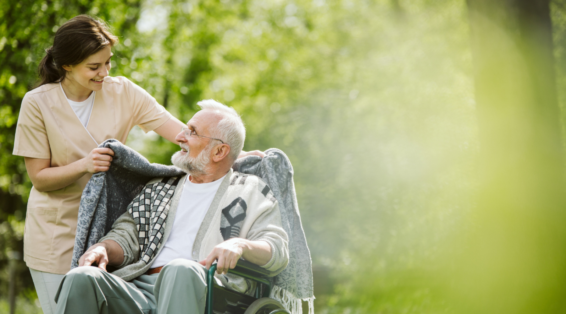 woman-caregiver-with-a-man-in-a-wheelchair